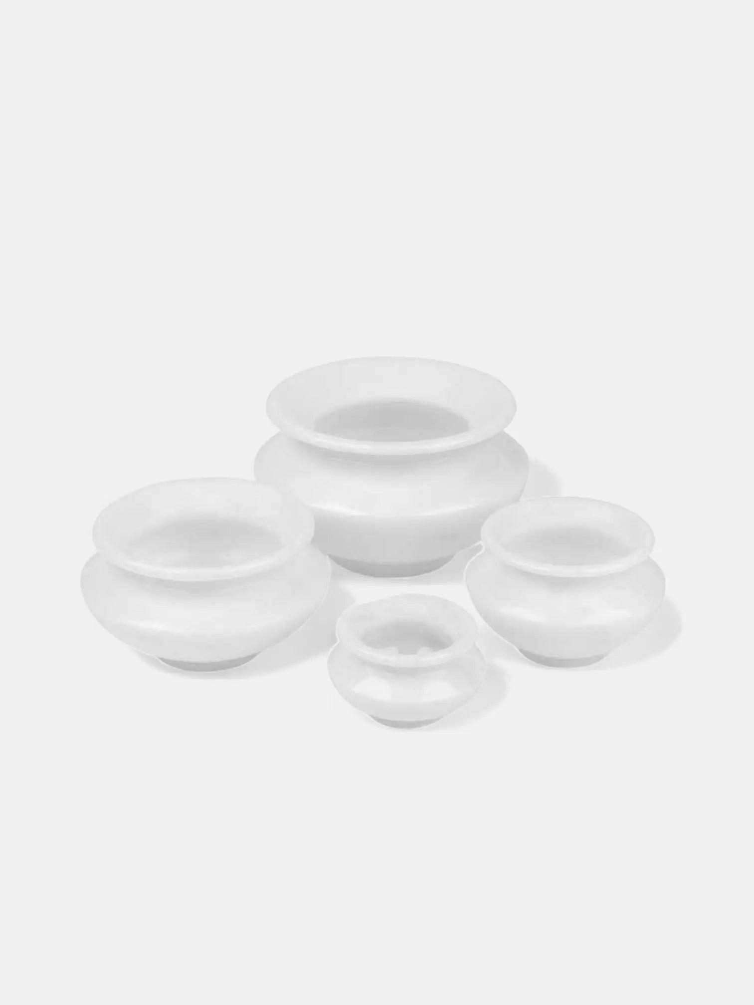 Set of 4 White Marble Candle Pots.